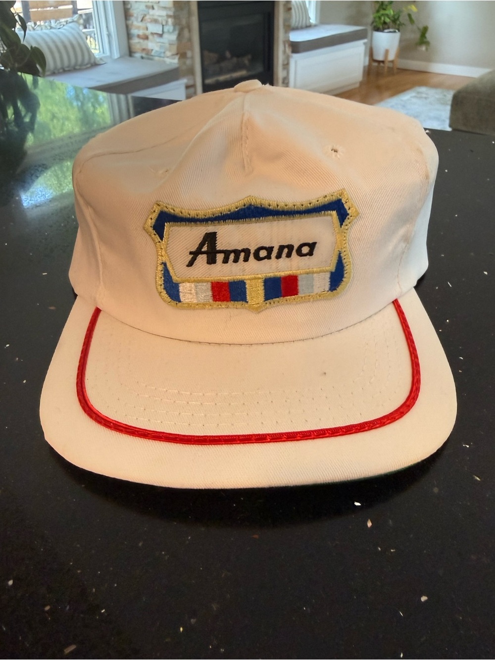 Amana White Cap with Red Trim and Blue-Yellow Patch